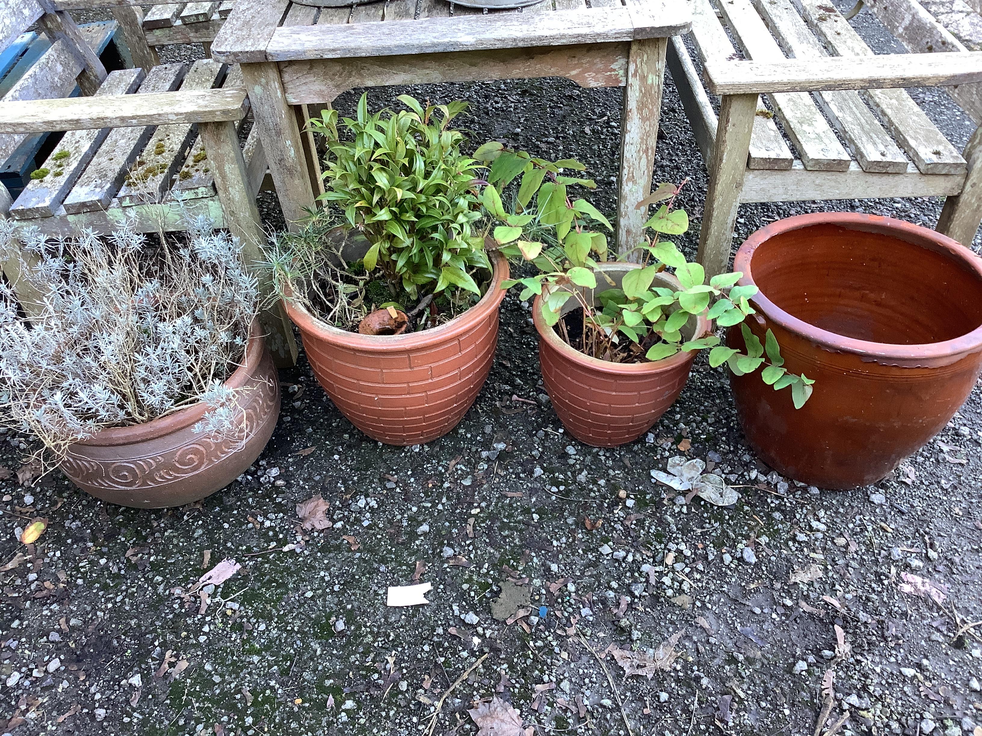 Four circular terracotta garden planters, largest diameter 38cm, height 36cm